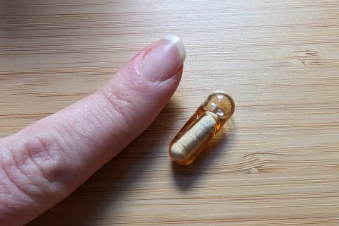 Clairvee capsule next to finger to show size by tester