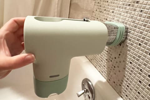 Tester installing Jade Canopy Bath Tub Filter onto bathtub spout