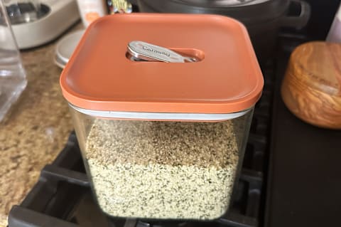 Caraway Airtight Glass Container Set in perracotta on stove stop with hemp seeds and airtight seal open