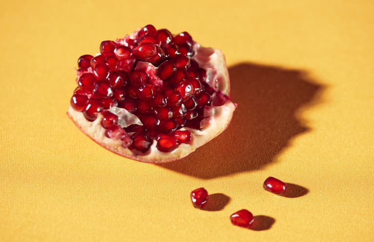 Closeup Of Pomegranate Seeds On A Yellow Background