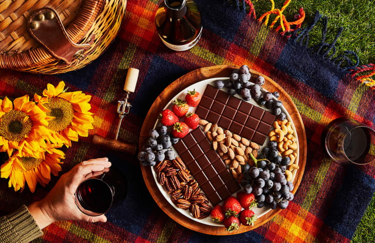 holiday spread with plate of chocolate, fruits, and nuts