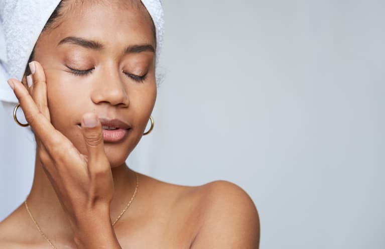 Woman Applying Skincare to Face