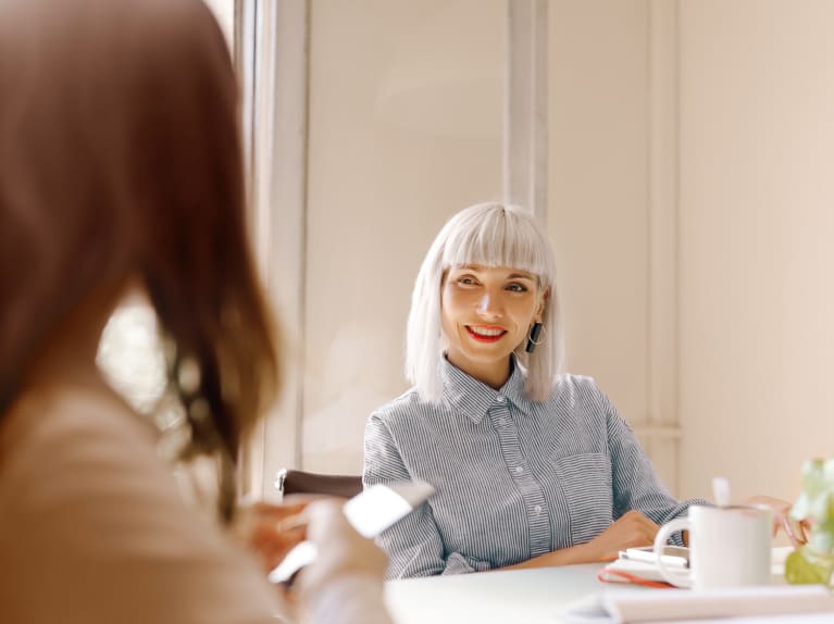 Two Women Talking in a Meeting