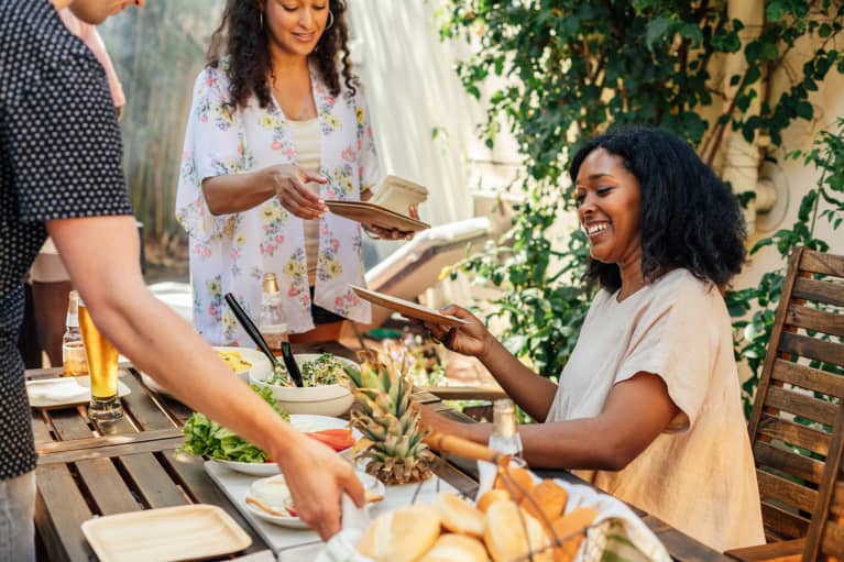 Friends together outside eating.