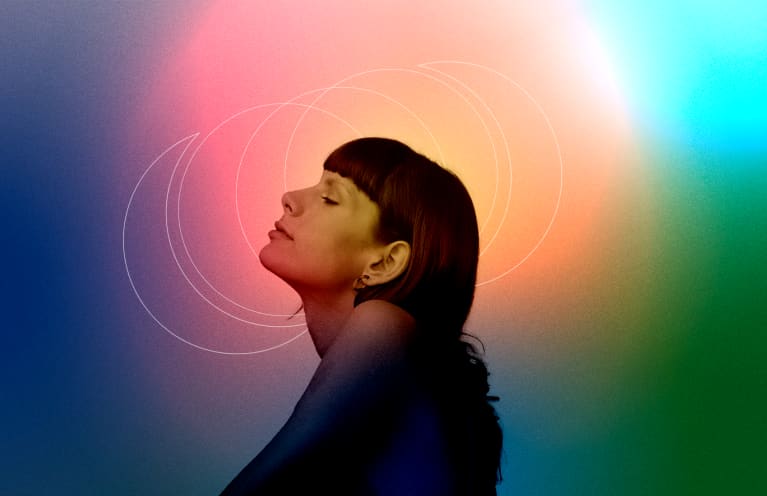 profile of a woman in front of colorful, mystical background