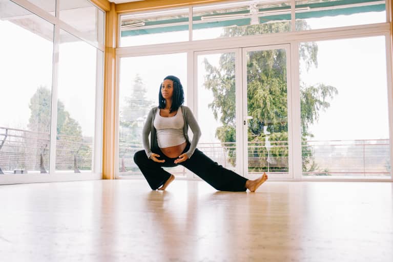 Pregnant Woman in Her Third Trimester Stretching in a Fitness Studio