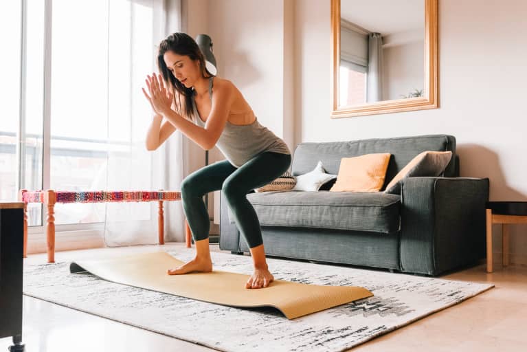 Woman Doing Squats During a Full Body Workout at Home