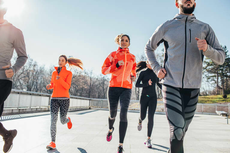 Group of Friends Running Outdoors in Cold Weather