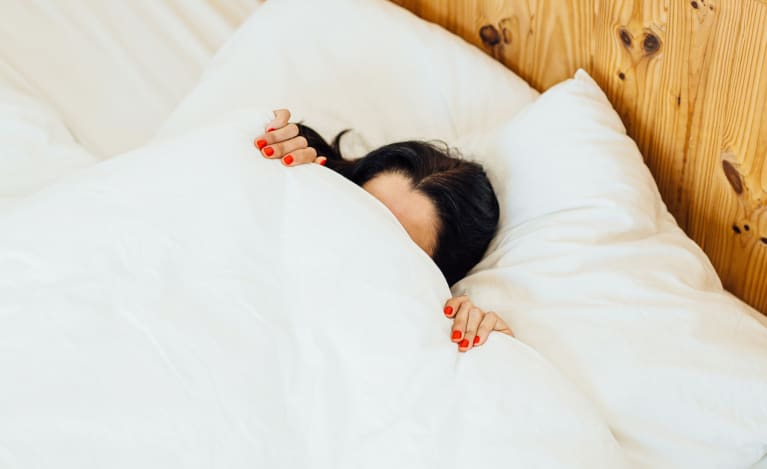 Woman Sleeping Under Covers