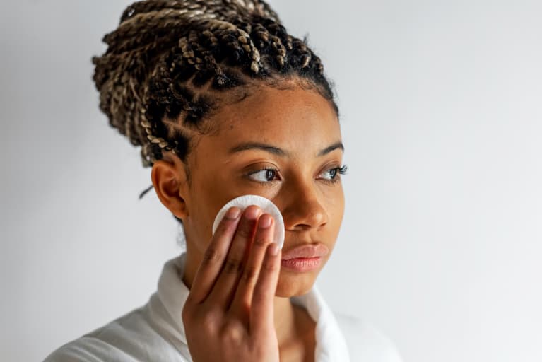 Black Woman Applying Tonic On Face Black Woman Applying Tonic On Face