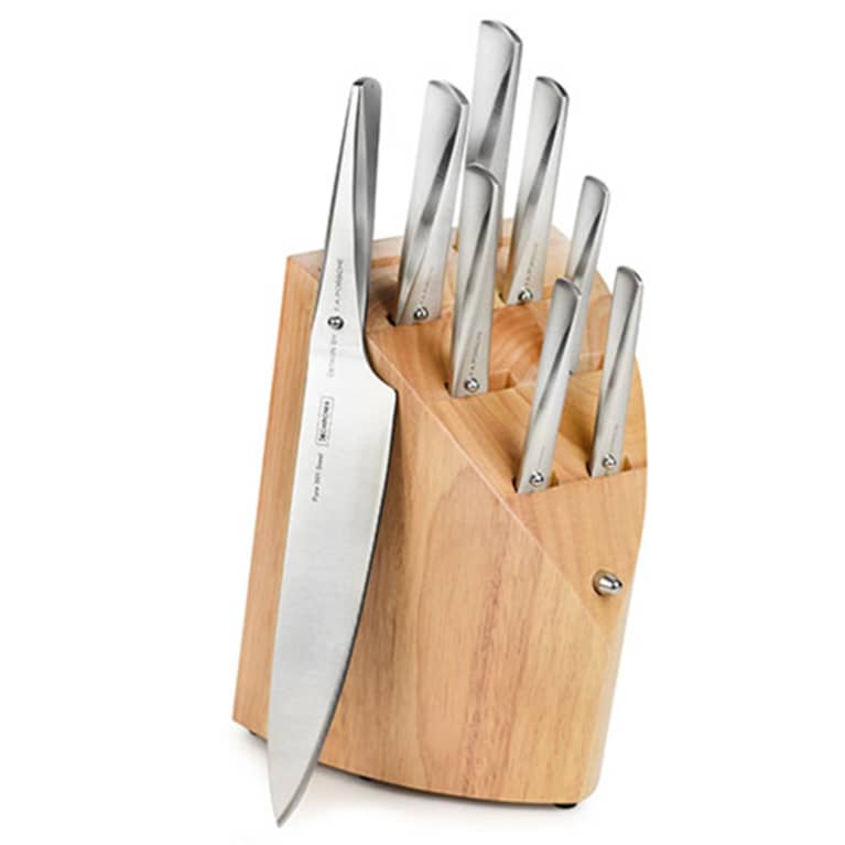 silver knives in wooden block 