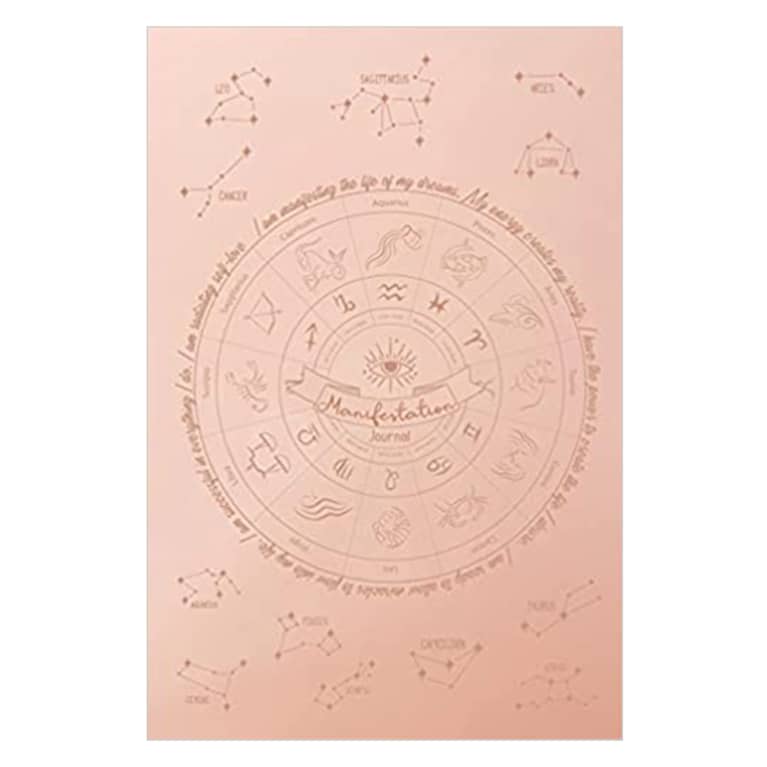 manifestation journal in pink with astrological symbols on cover