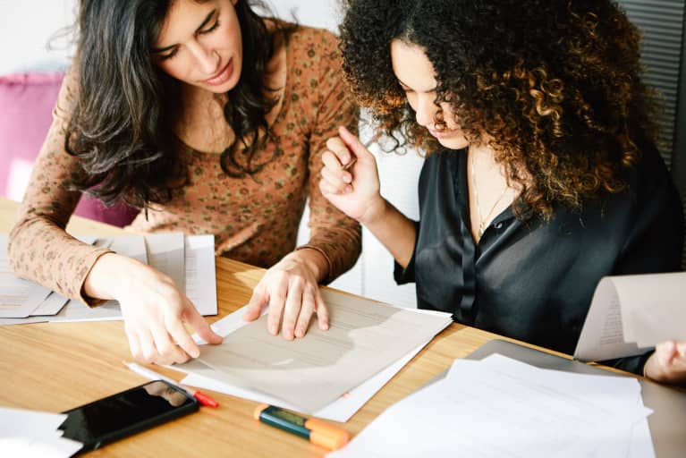 Woman Tutoring Another Woman in School