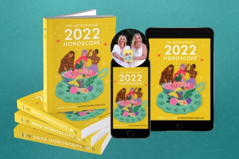 horoscope prediction book for 2022 with yellow cover on a phone and tablet