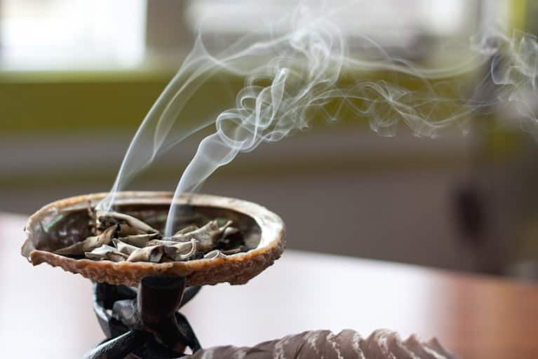 Smudging 101: Burning Sage To Cleanse Your Space & Self Of Negativity