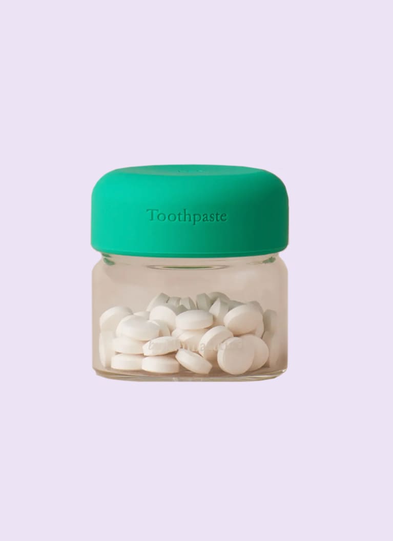 byHumankind toothpaste tablets in a jar with a green lid byHumankind toothpaste tablets in a jar with a green lid