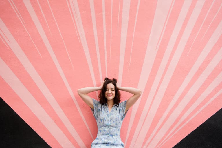 Woman Being Silly In Front Of Pink Wall