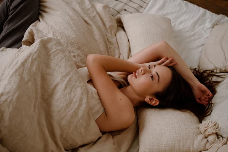 Young pretty woman lying on a bed 