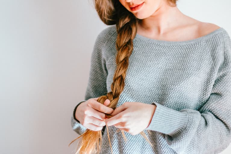 Woman Braiding Her Long Hair