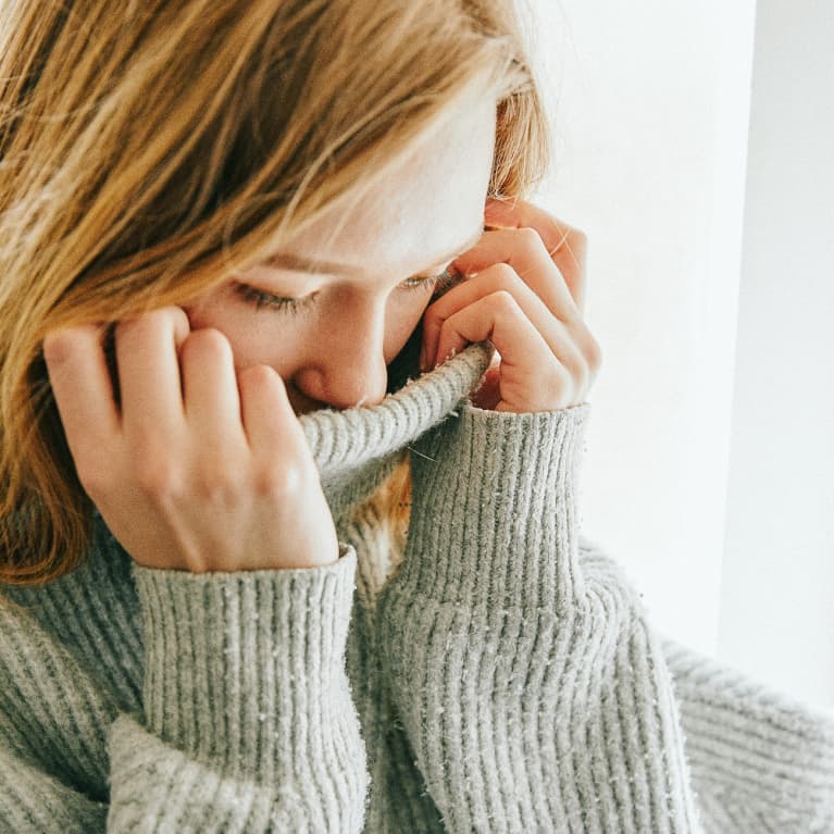 Upset Young Woman in a Turtleneck