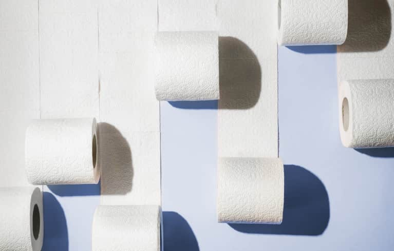 Abstract minimal shot of toilet paper rolls on blue-purple seamless