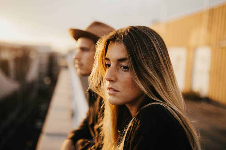 Sad Thoughtful Woman Standing Outside with Her Partner