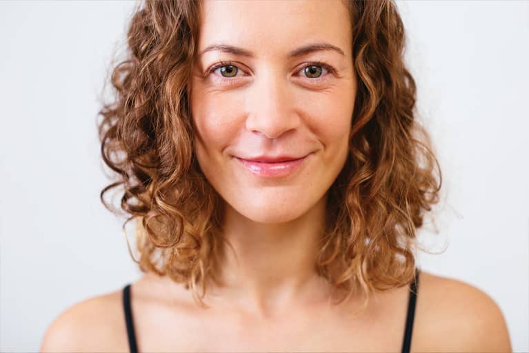woman with under eye bags smiling at camera
