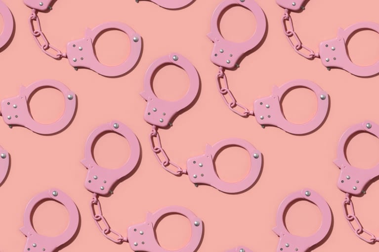 Pink Handcuffs Repeating on a Coral Background