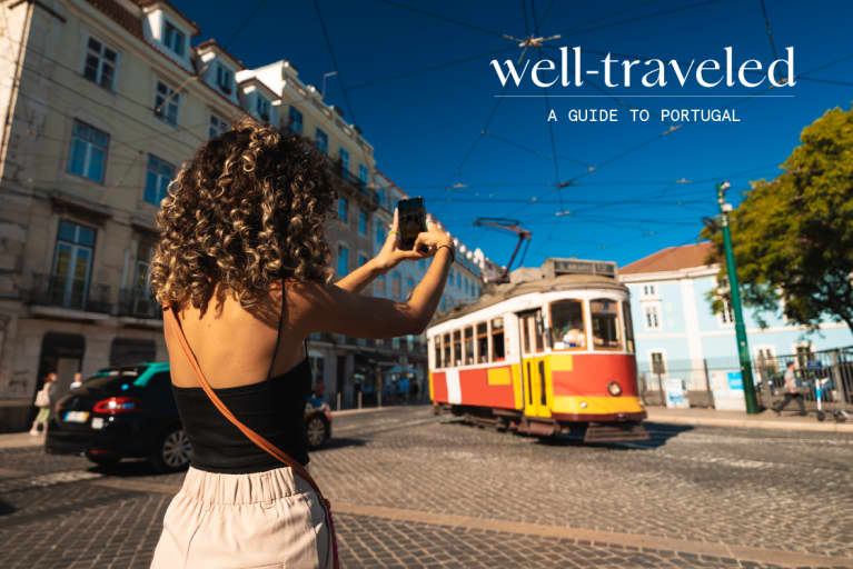 Woman taking a photo in Lisbon, Portugal
