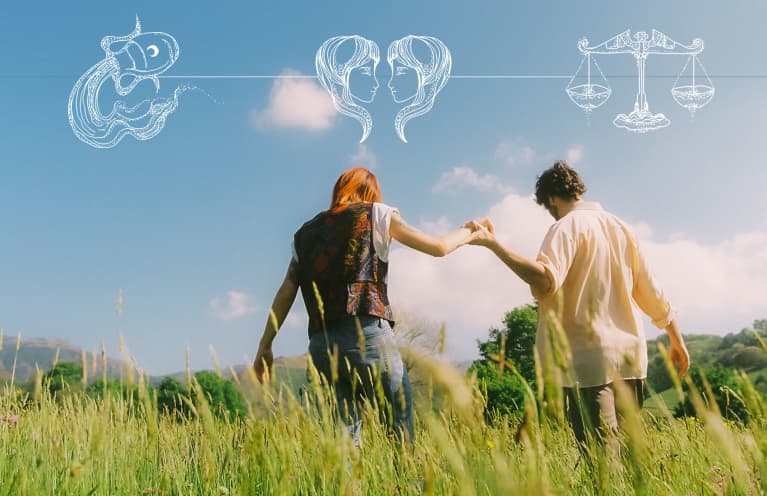 two people holding hands in green field with astrological overlay two people holding hands in green field with astrological overlay