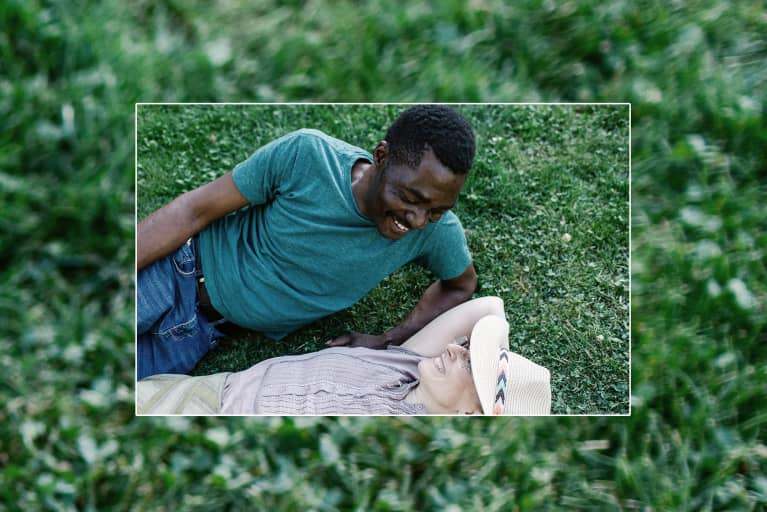 couple in their 40s laying in the grass