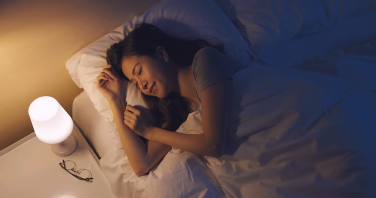 Women sleeping in bed with a nightlight