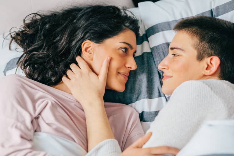 Couple Smiling Together In Bed In The Morning