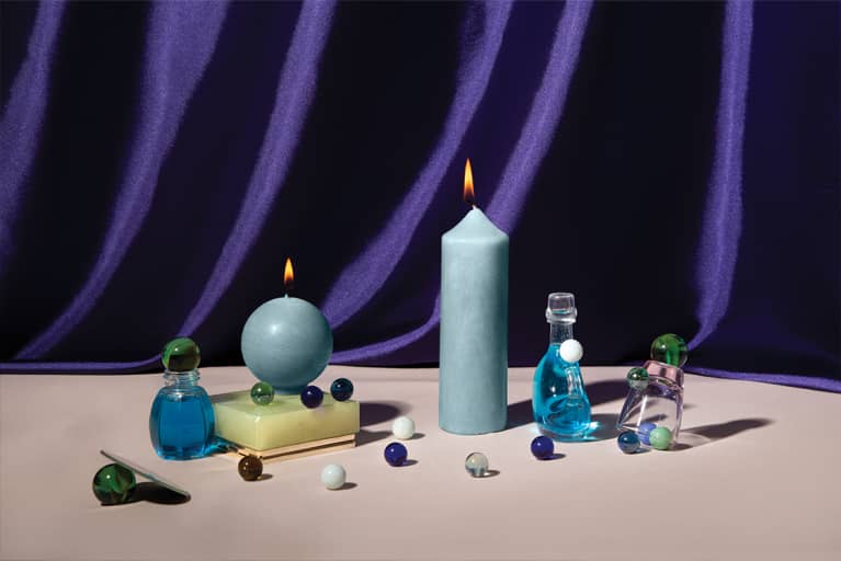 photo of clue candles and assorted crystals in front of purple background