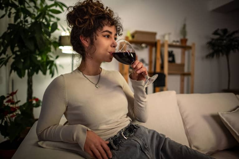 woman drinking wine on the couch
