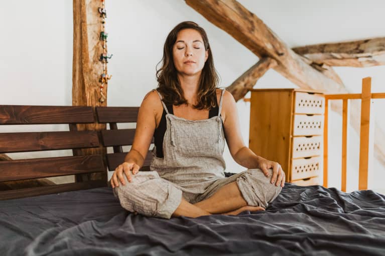 Woman Meditating in Her Bed