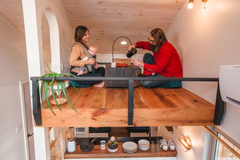 couple with young baby sitting together having tea couple with young baby sitting together having tea