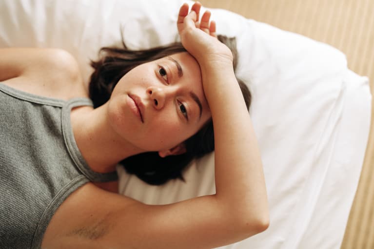 Woman Laying in Bed with Racing Thoughts