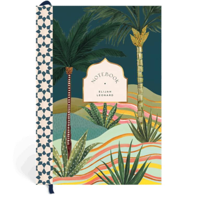 notebook with palm tree scene on cover