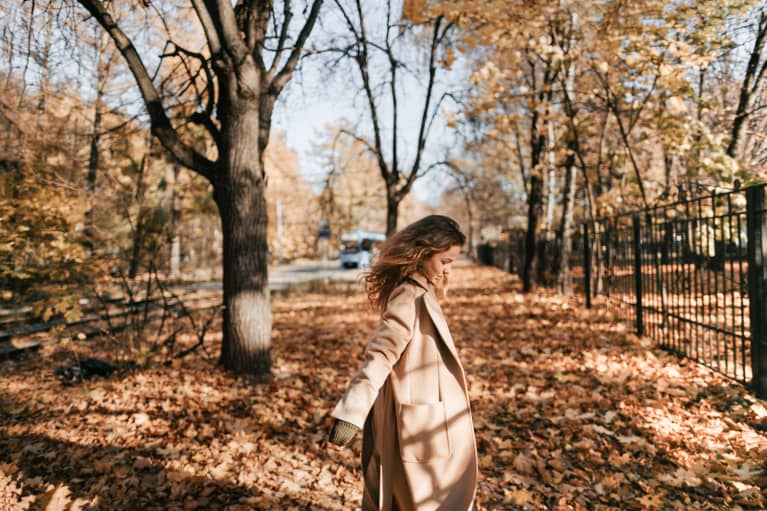Woman Dancing in Autumn Leaves