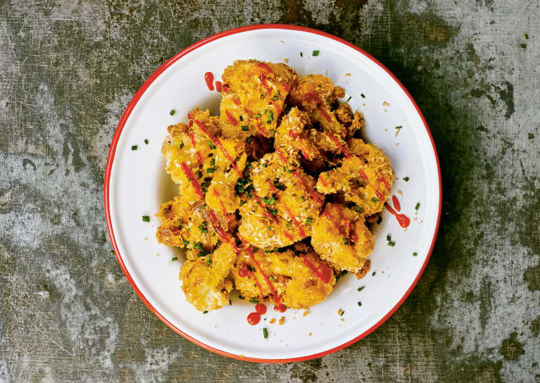 crispy cauliflower nuggets on white plate with red rim