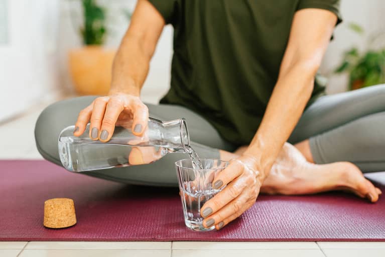 Woman pouring water into a glass