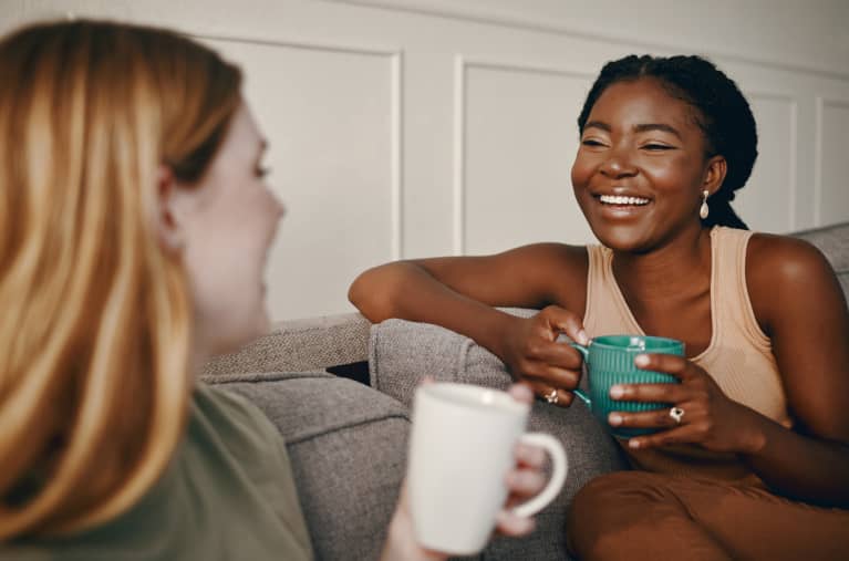 two women drinking coffee