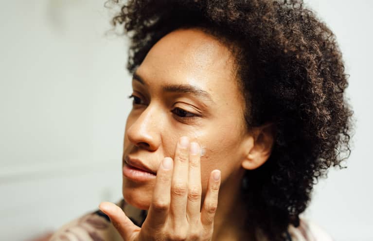 Close Up Of A Woman Putting Lotion On Her Face Close Up Of A Woman Putting Lotion On Her Face