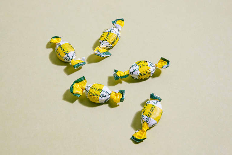 Five Natural Cough Drops on a Green Background