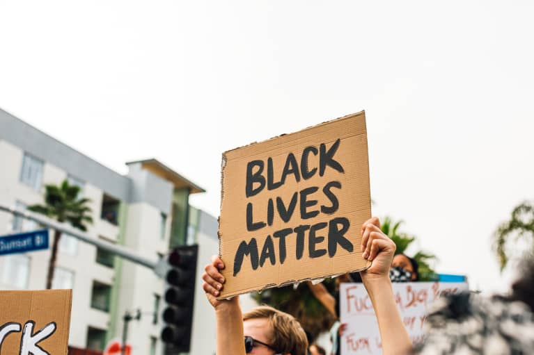Person Holding up a Black Lives Matter Sign in a Protest