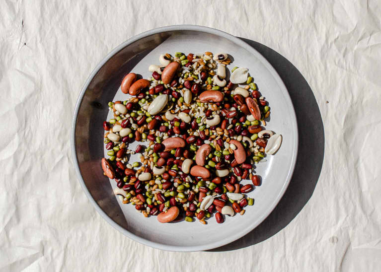 chinese eight treasure congee — kidney beans, adzuki beans, green beans, peanuts on ceramic plate
