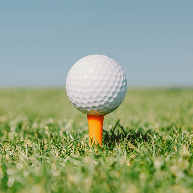 Golf Ball In An Orange Tee