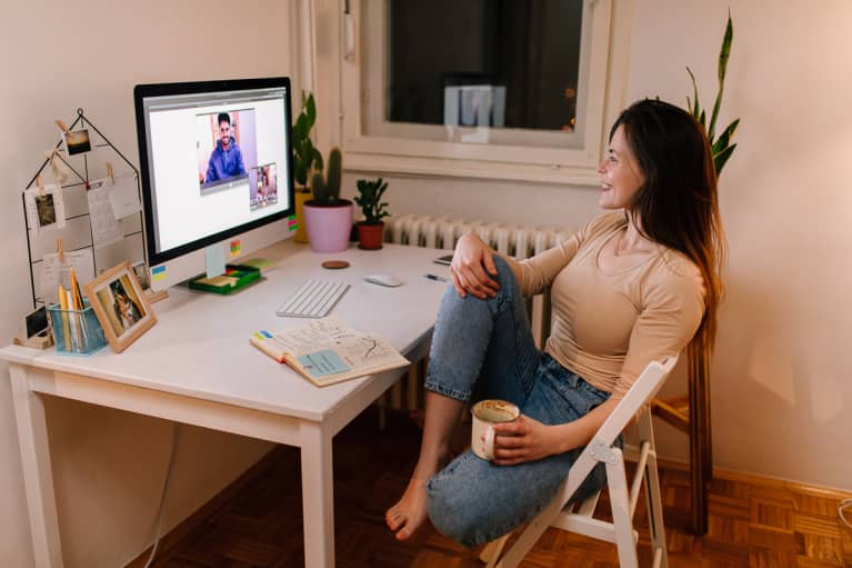 Young woman sitting at her desk on a video call