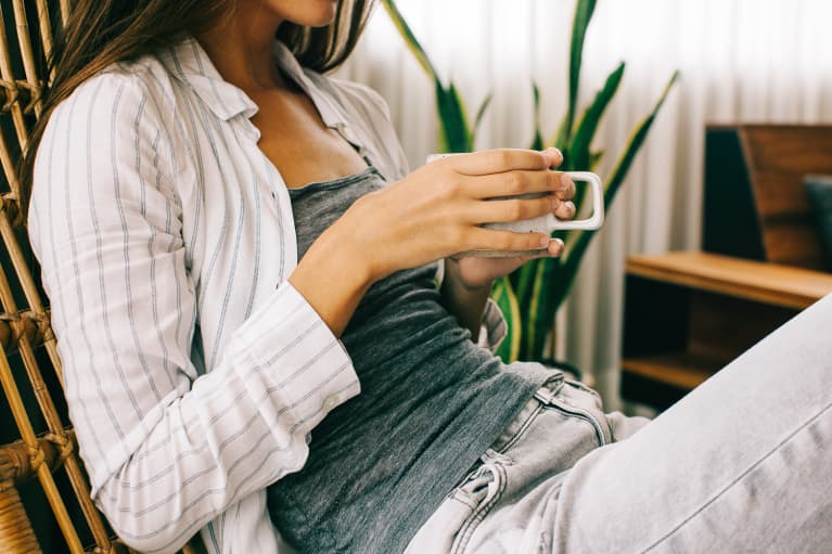 Unrecognizable Woman Relaxing At Home Drinking Tea